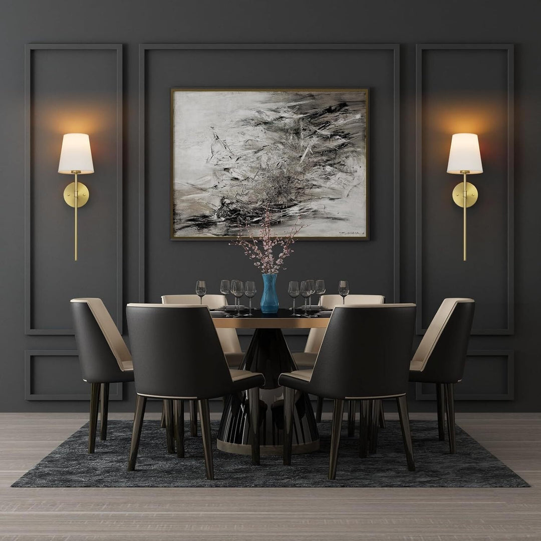 A pair of gold NovaGlow luxury wall lamps illuminating a stylish dining room wall