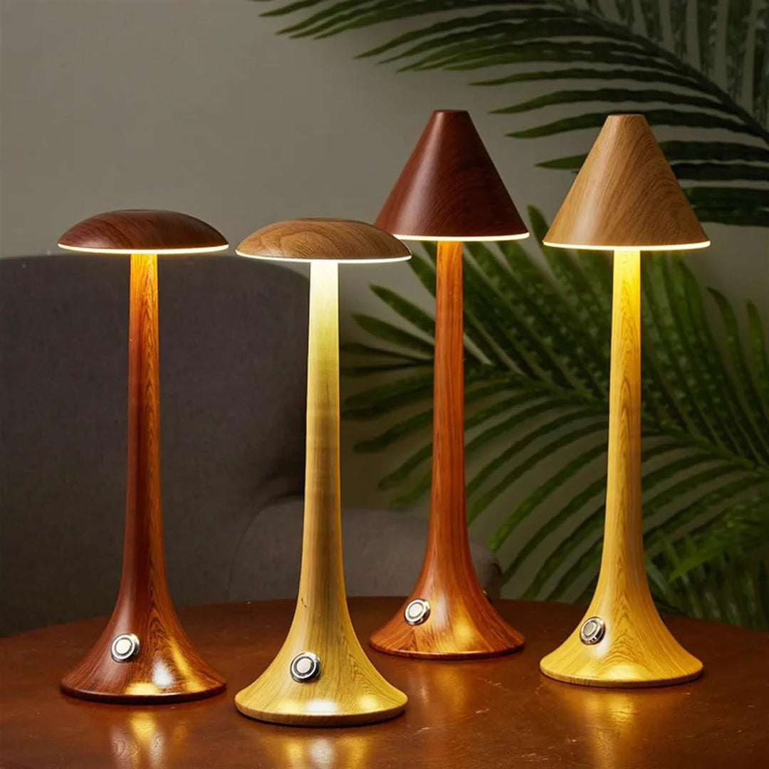 Four different mushroom table lamp variants illuminated on a wooden surface