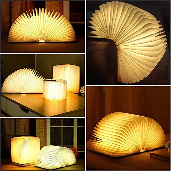 Foldable wooden book light open on a dark table showing warm LED illumination