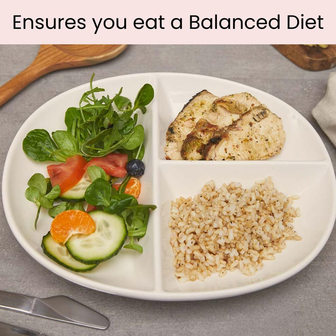 White porcelain portion control plate filled with balanced meal of fish, rice, and salad