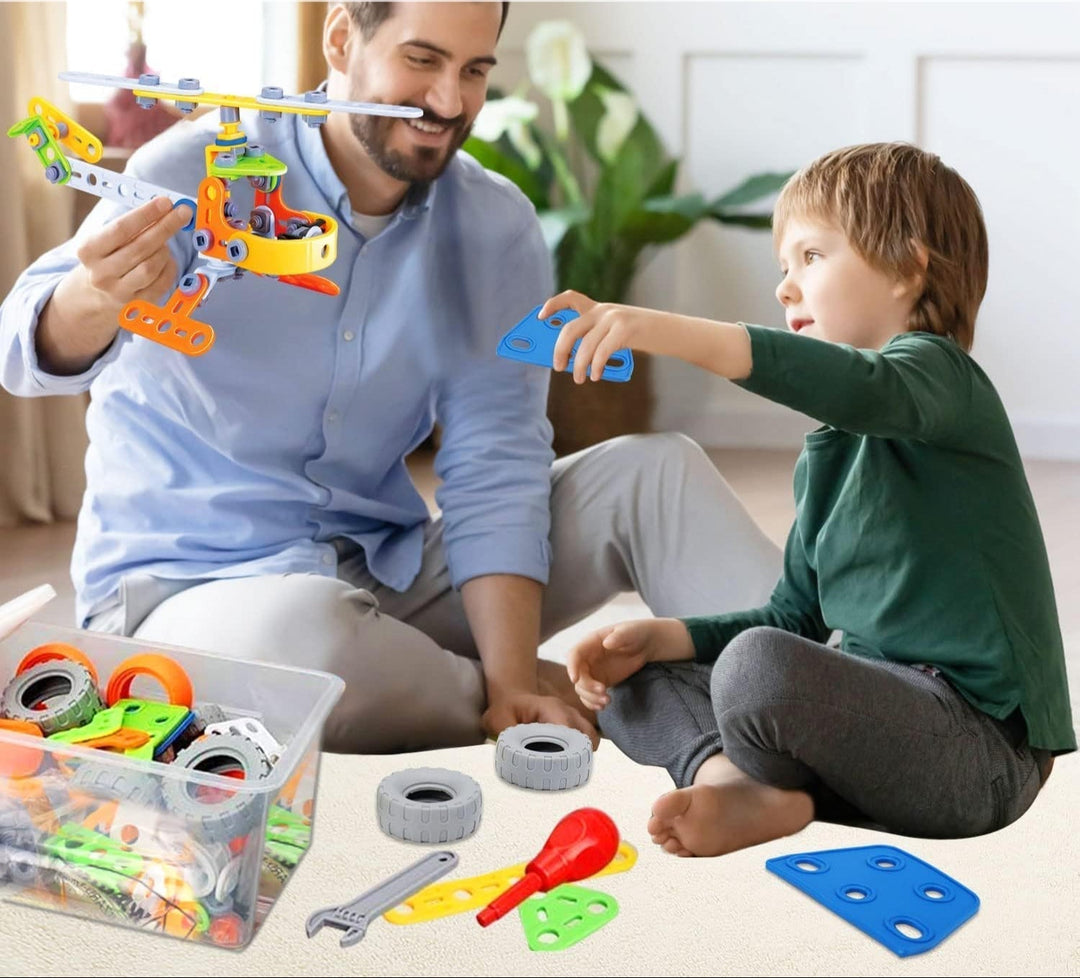 Father and child assembling a toy helicopter together indoors