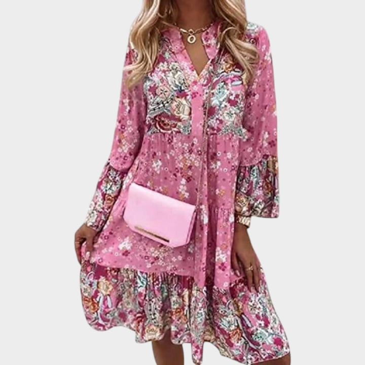 Woman wearing pink floral boho mini dress with matching crossbody bag
