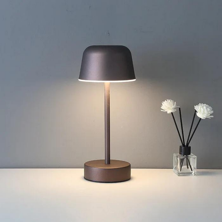 Minimalist home lighting piece displayed on a wooden shelf in daylight