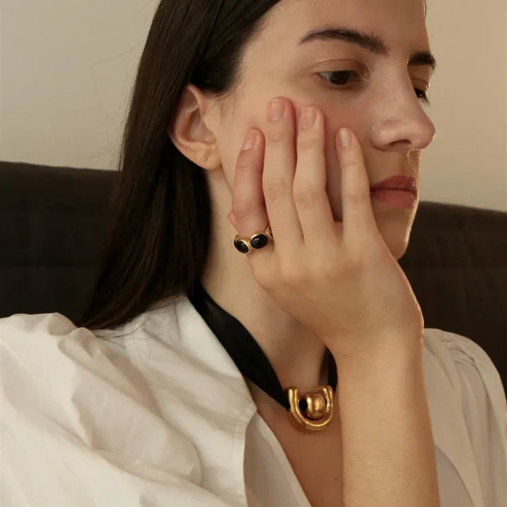Women's gold-plated statement ring featuring a striking black onyx gemstone.