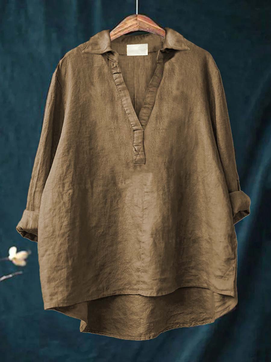 Khaki women's long sleeve blouse hanging against dark background