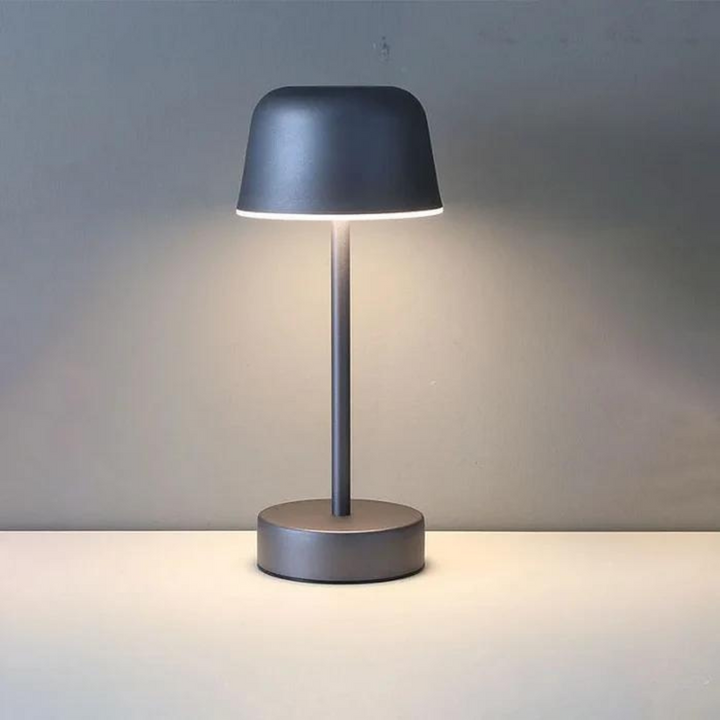 Contemporary LED table lamp casting a gentle ambient glow on a living room table