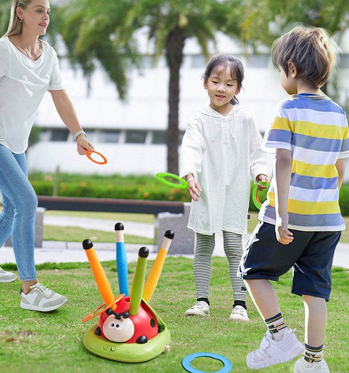 Children playing the ring toss activity in an outdoor park setting
