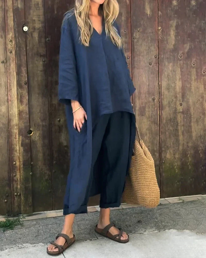 Full view of a woman in a relaxed-fit dark blue two-piece summer apparel set