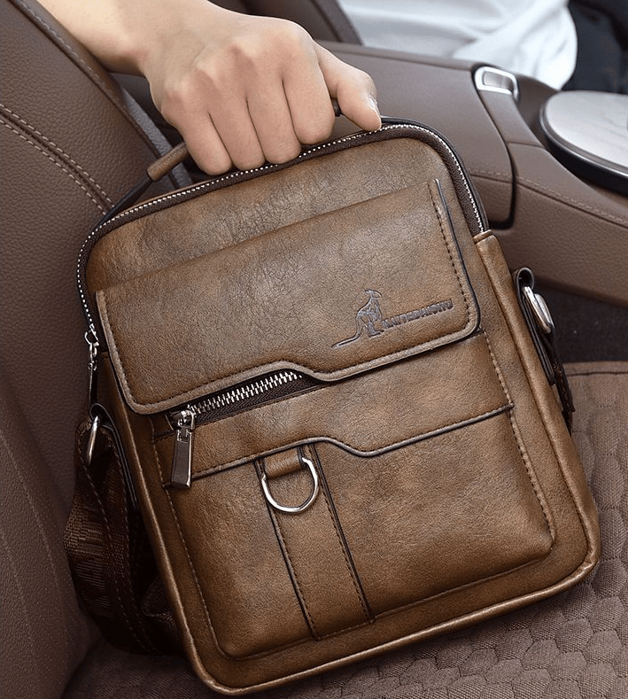 Crossbody utility bag in brown, showcasing adjustable strap and durable fabric