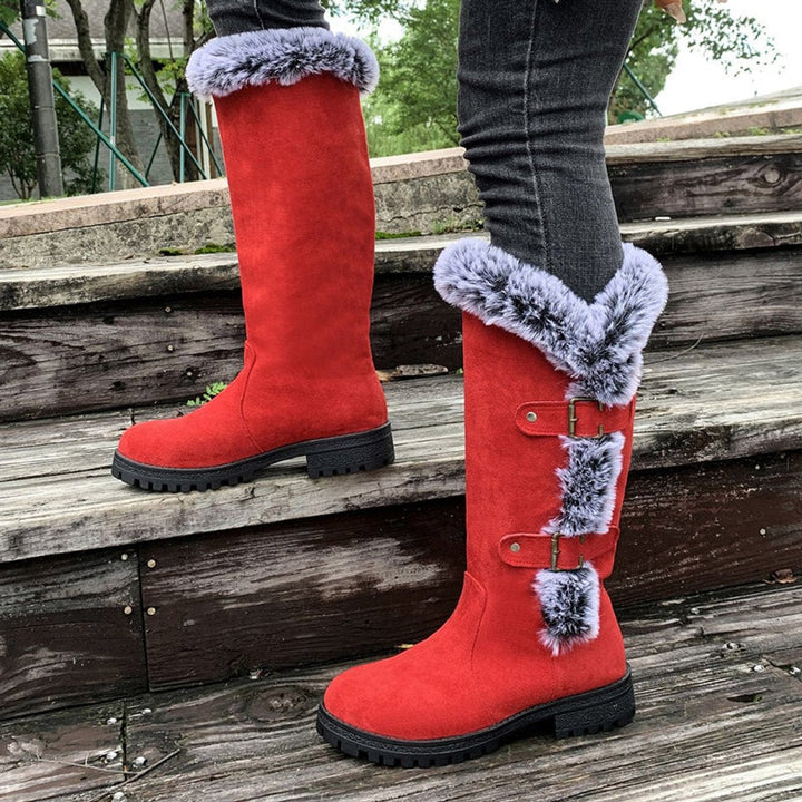 Side view of womens knee-high boots featuring stylish buckle straps