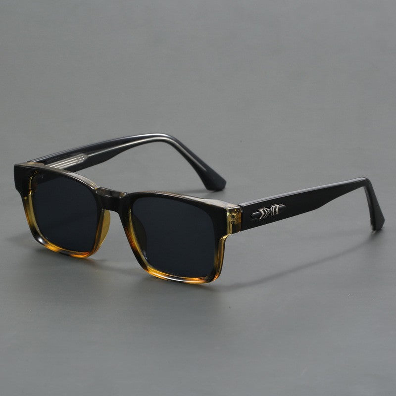 Overhead flat lay of unisex square sunglasses and stylish fashion accessories