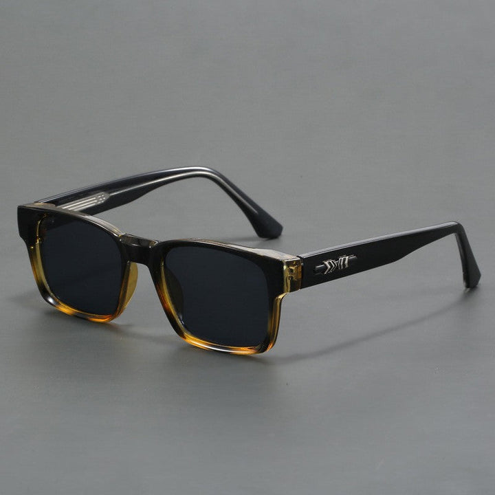 Overhead flat lay of unisex square sunglasses and stylish fashion accessories
