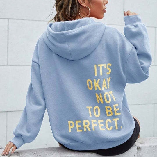 Back view of a woman wearing a blue relaxed hoodie with yellow letter print