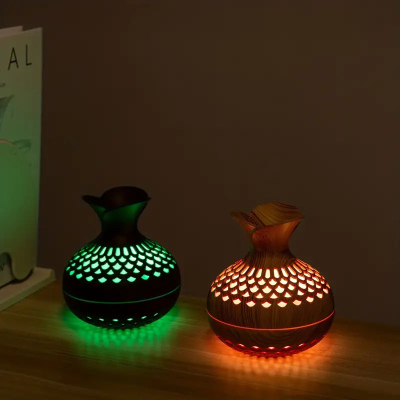 Black and Brown aroma diffusers glowing side by side in a dark room