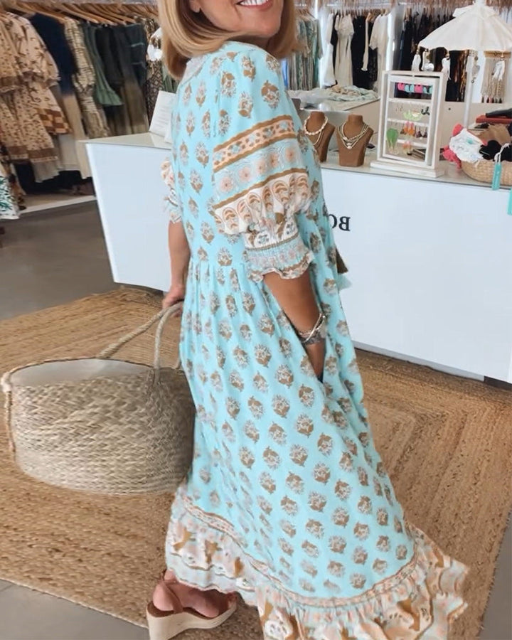 Side view of model wearing blue Verona printed dress with ruffled details