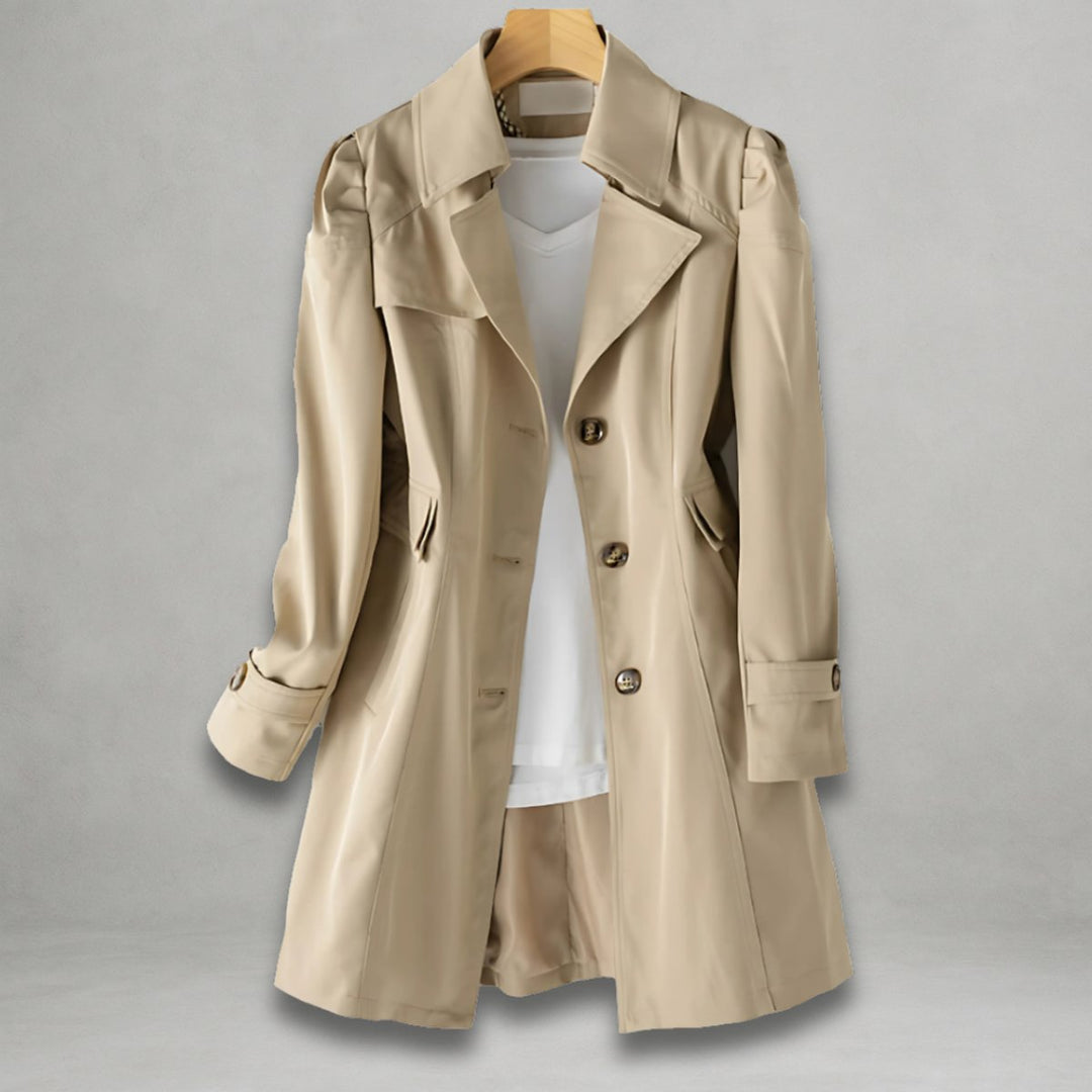 Beige women's single-breasted trench coat hanging on a wooden hanger