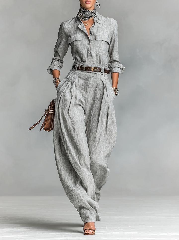 Full-length view of a woman wearing a gray long-sleeve shirt and matching wide-leg trousers set.
