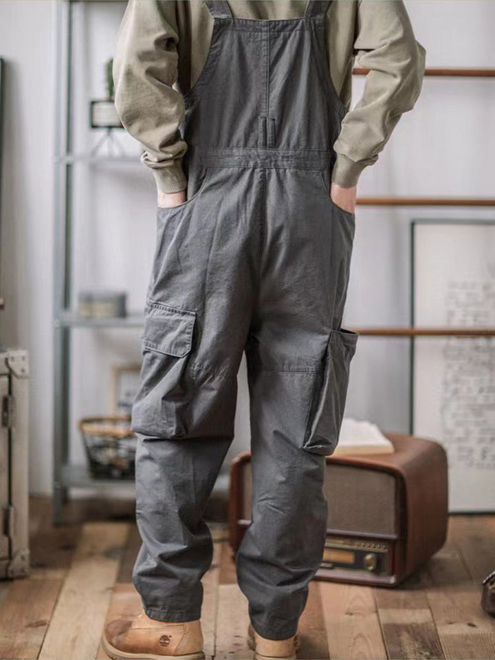 Folded men's utility overalls displaying rugged texture and quality fabric