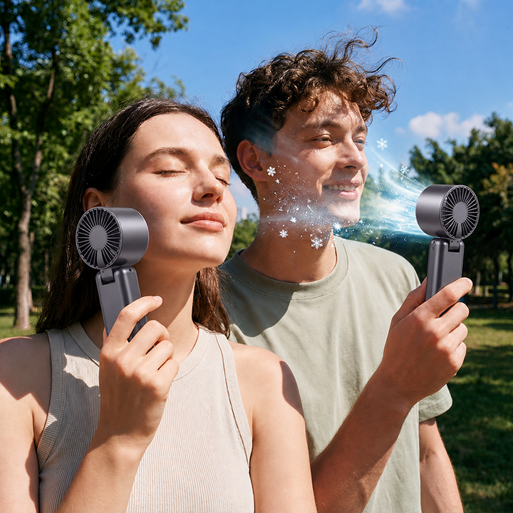 Man and woman enjoying refreshing breeze outdoors with portable cooling fans