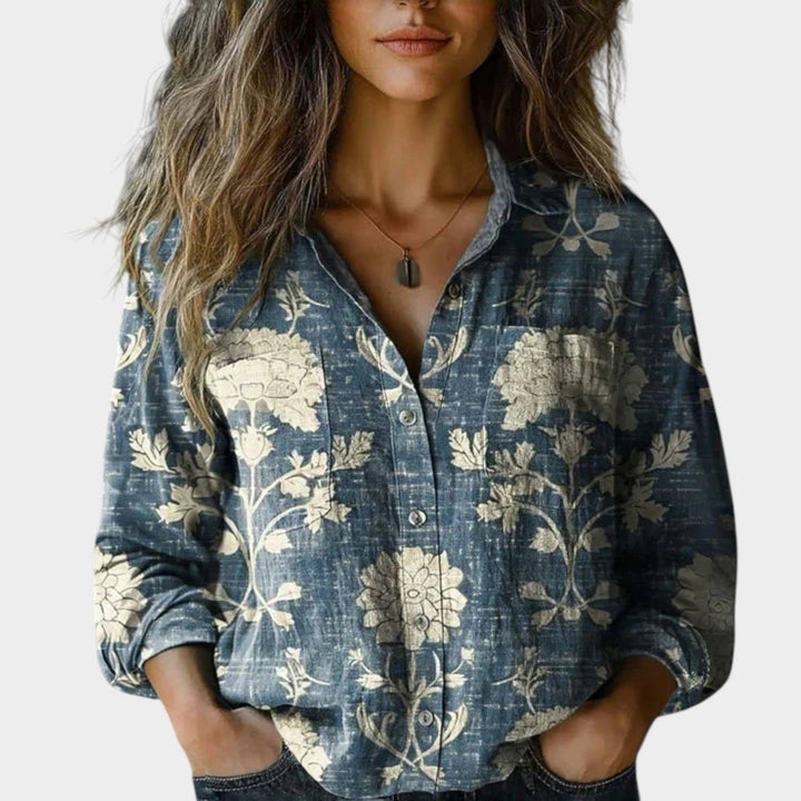 Woman wearing a blue patterned retro button-up shirt with classic collar