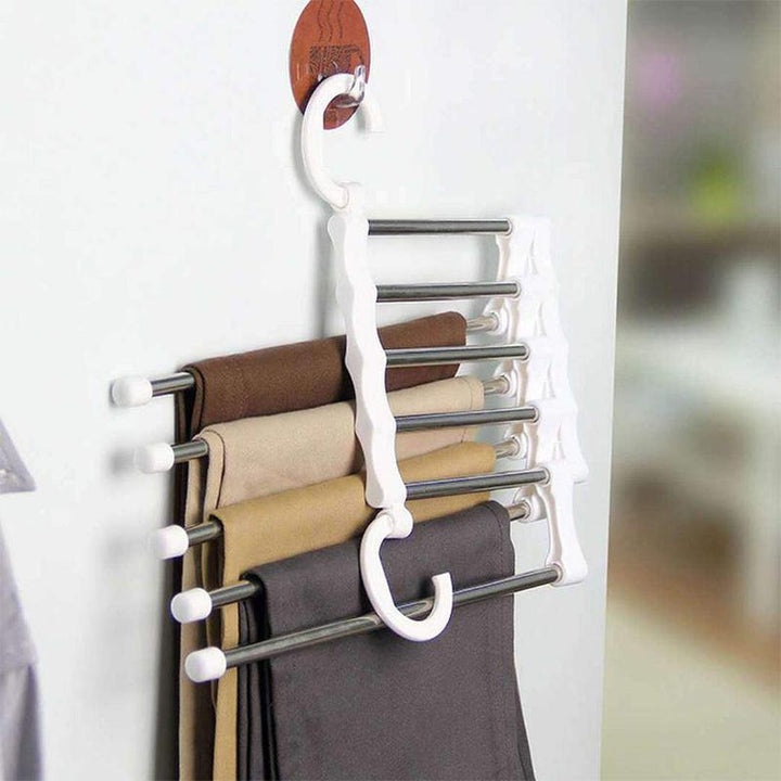 User hanging slacks on the innovative magic pants hanger for wardrobe storage