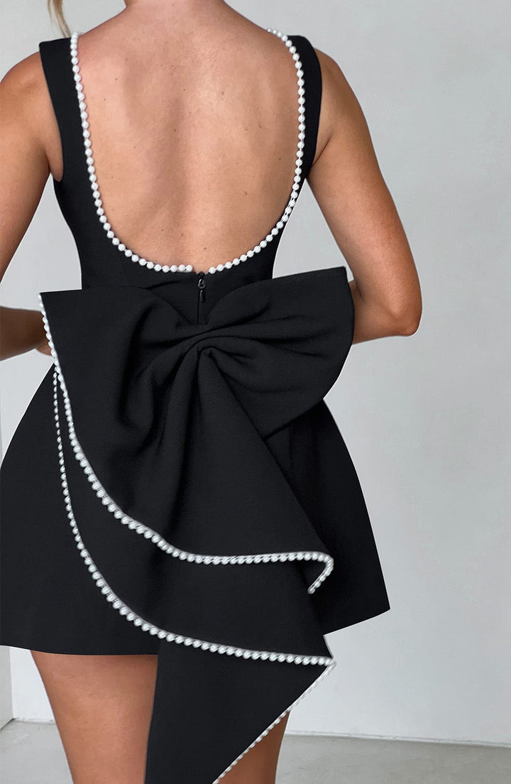 Detailed shot of fabric and pearl trim on wedding guest mini dress