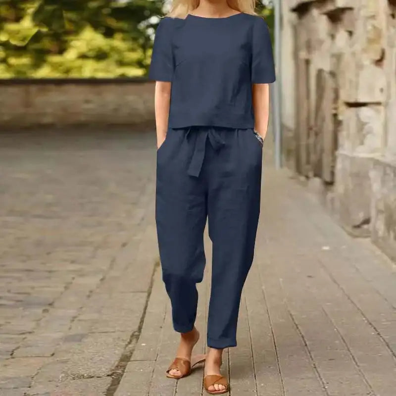 Woman wearing navy blue two-piece set walking outdoors