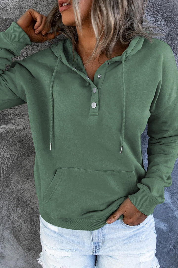 Comfortable black hooded sweater worn by a model