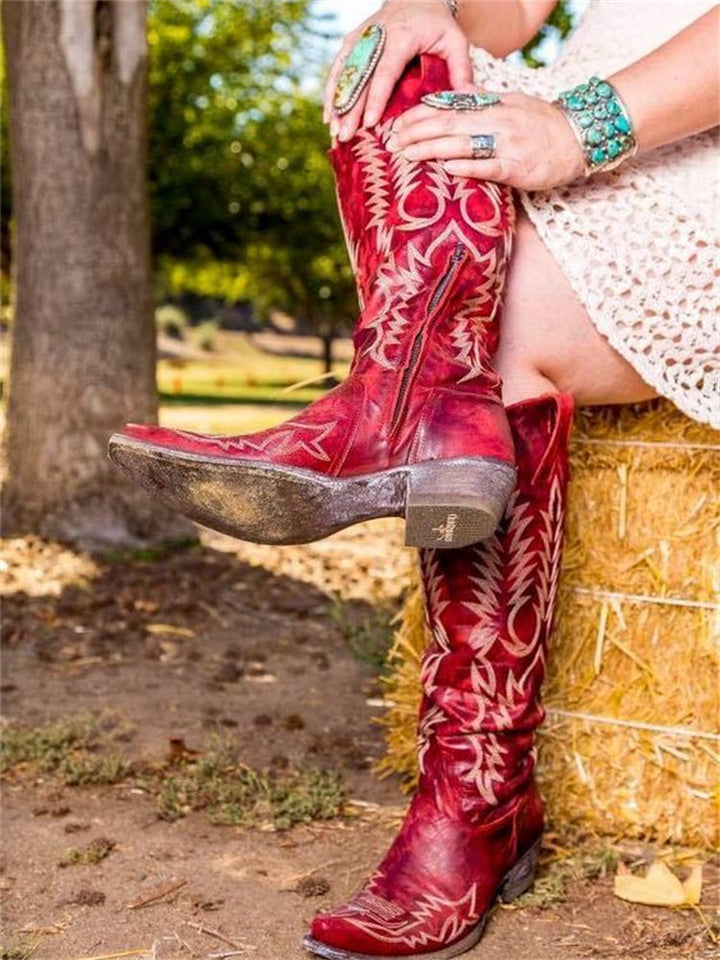 Angled view of trendy women's tall vintage western boots with classic pointed toe