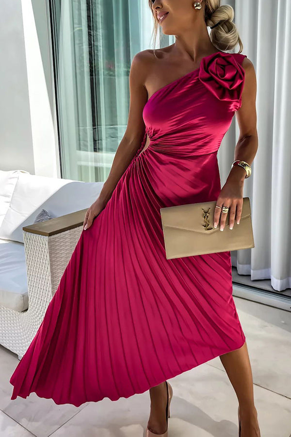 Woman wearing a vibrant rose red floral dress with shoulder flower detail and holding a matching clutch