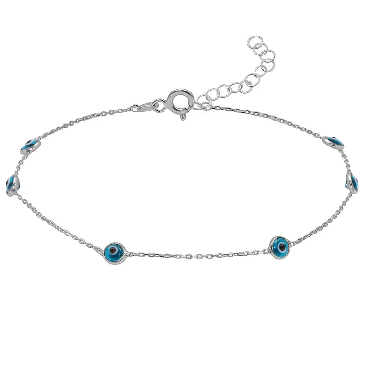 Silver evil eye anklet laid flat against a white background