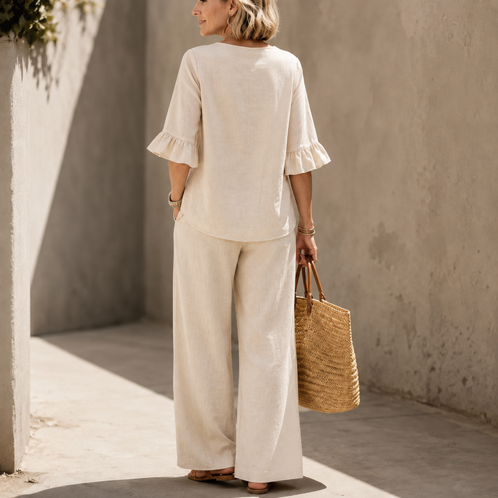 Full-length view of womens summer two-piece outfit featuring wide-leg trousers and ruffle top