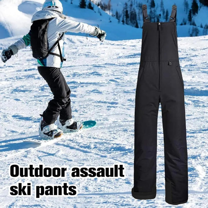 Snowboarder riding down a snowy slope wearing ski trousers