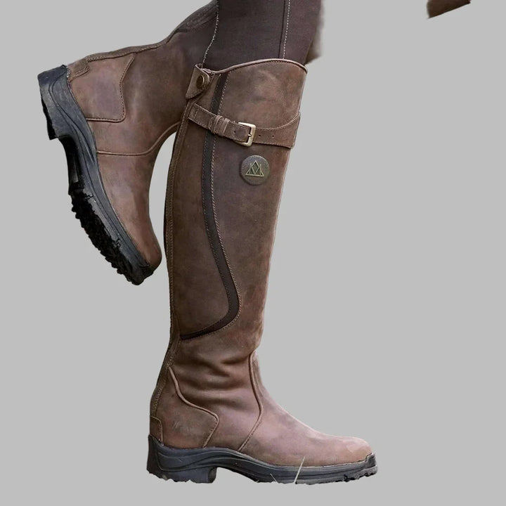 Side profile of dark brown tall boots worn with fitted trousers