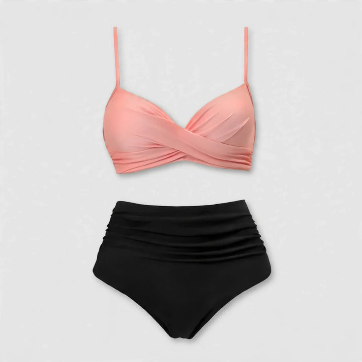 Flat lay view of a pink twist-front bikini top and black high waist bottoms