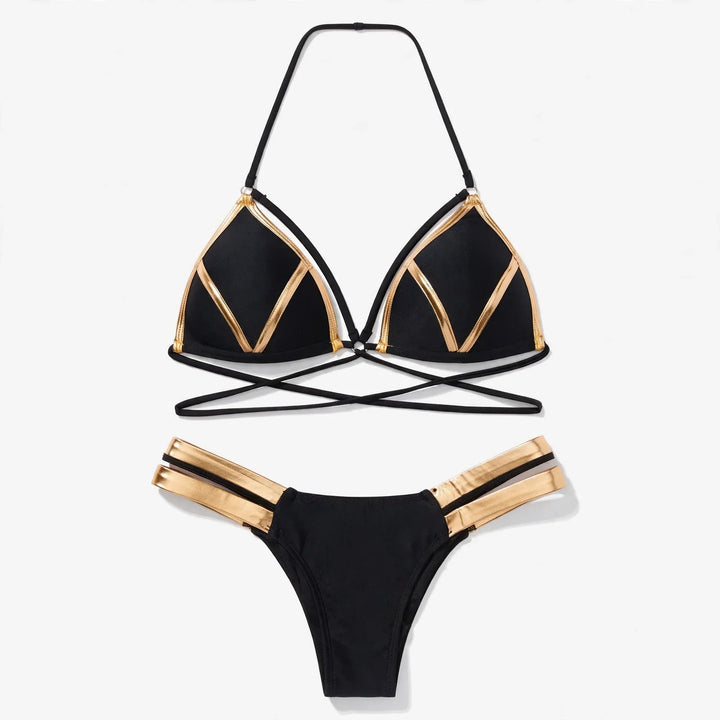 Flat lay of the black and gold strappy push-up bikini set
