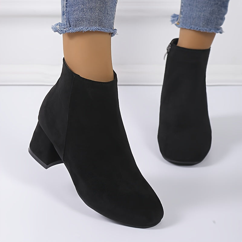 Angle shot of women's brown chelsea ankle boots styled on a model