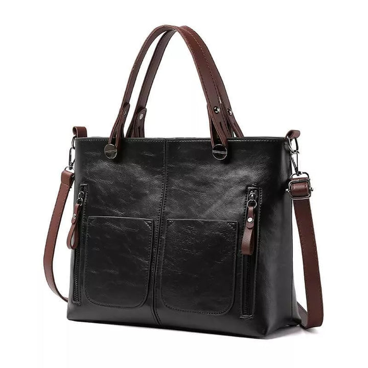 Crossbody bag for women worn on shoulder demonstrating adjustable strap drop length