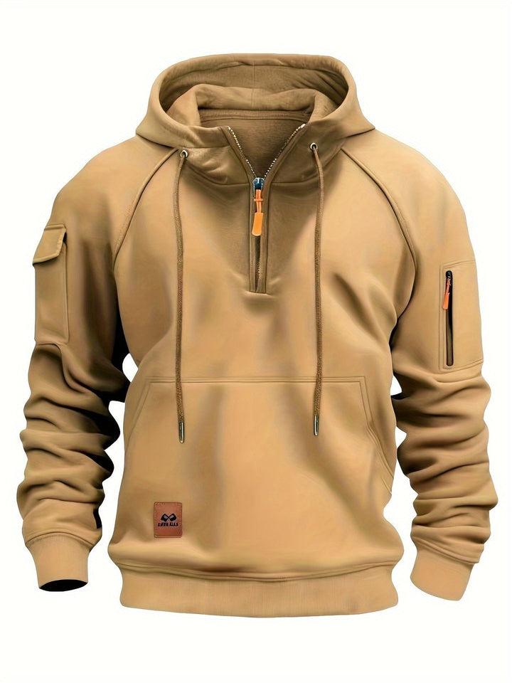 Model wearing men's outerwear hoodie outdoors during cool weather.