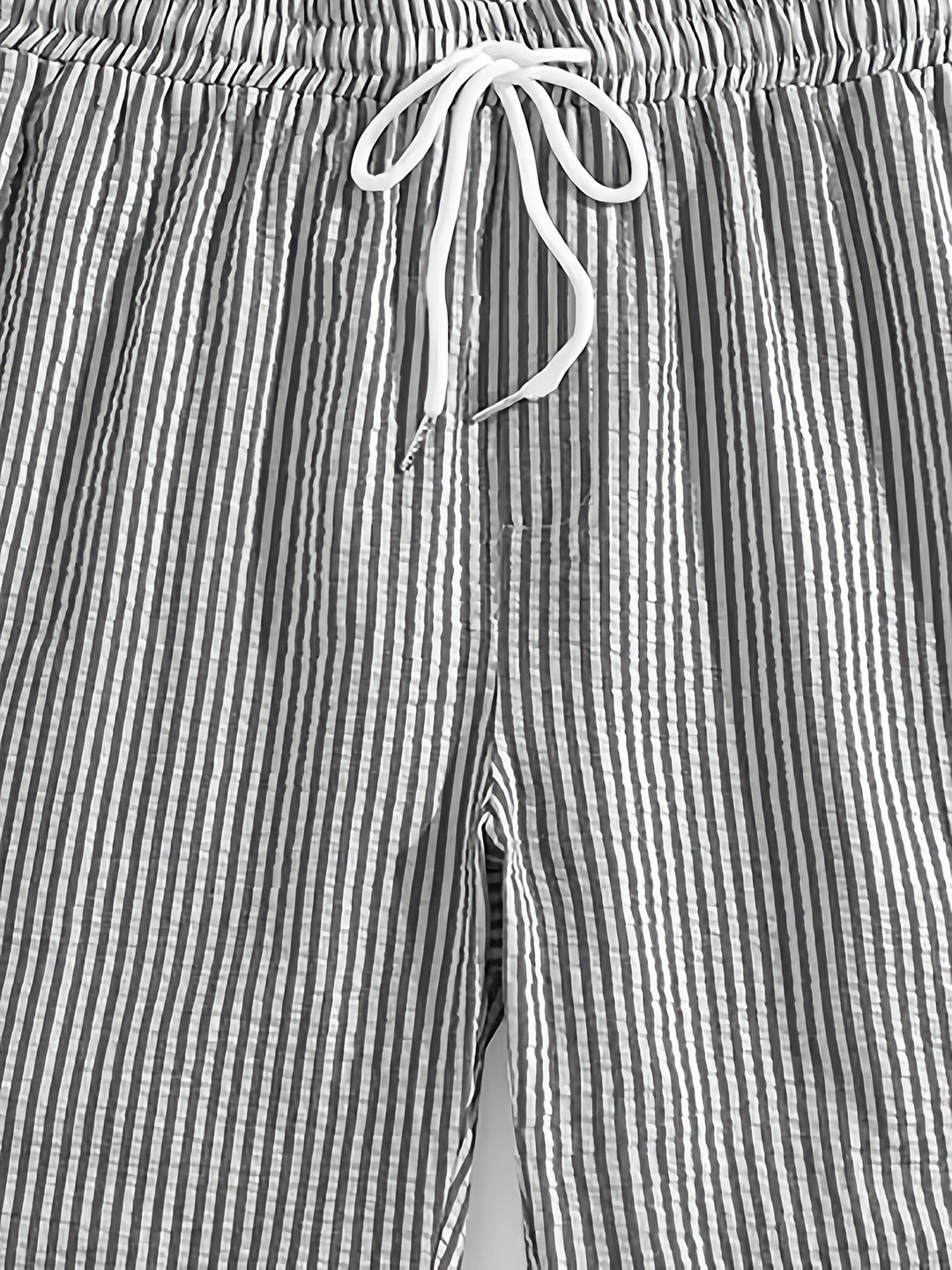 Model wearing mens summer wear striped shorts in casual lifestyle setting
