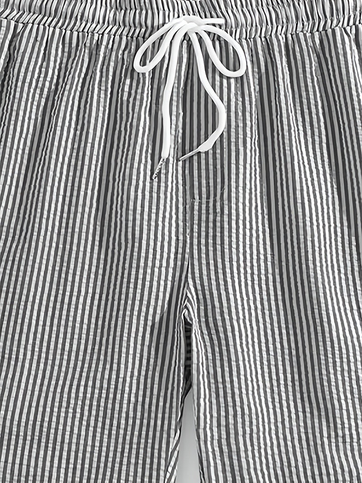 Model wearing mens summer wear striped shorts in casual lifestyle setting