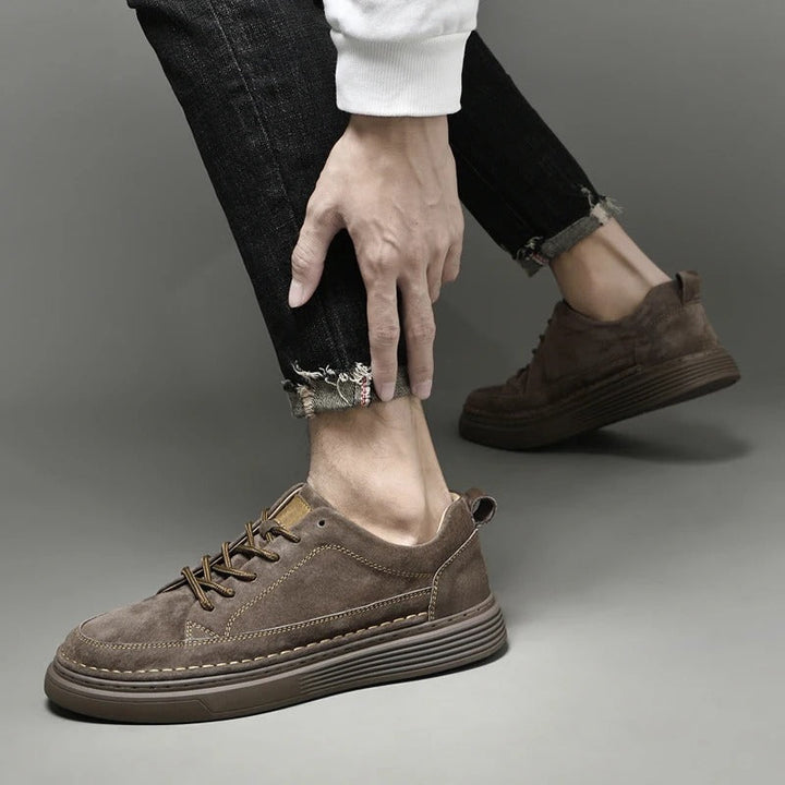 Close-up of footwear texture and stitching on men's leather sneakers