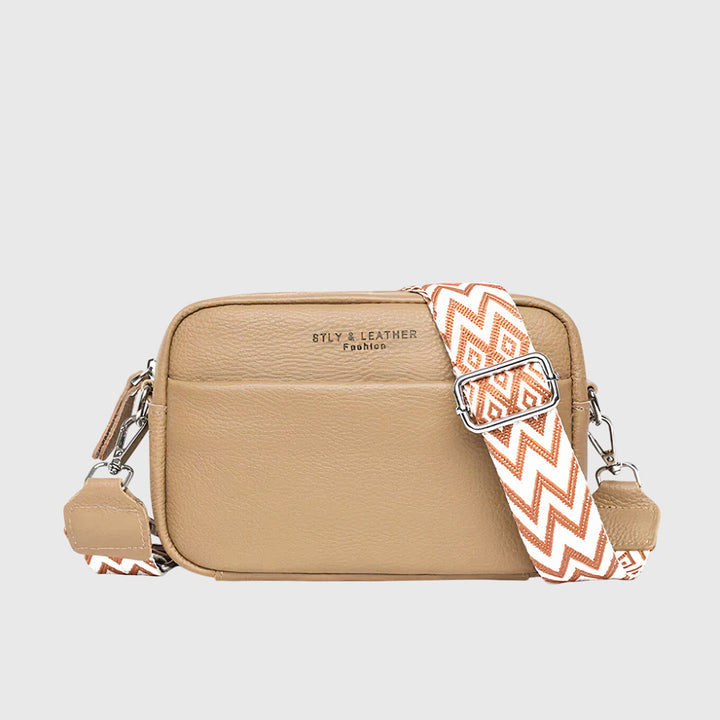 Close-up view of the adjustable wide patterned strap attached to the women's everyday shoulder bag.