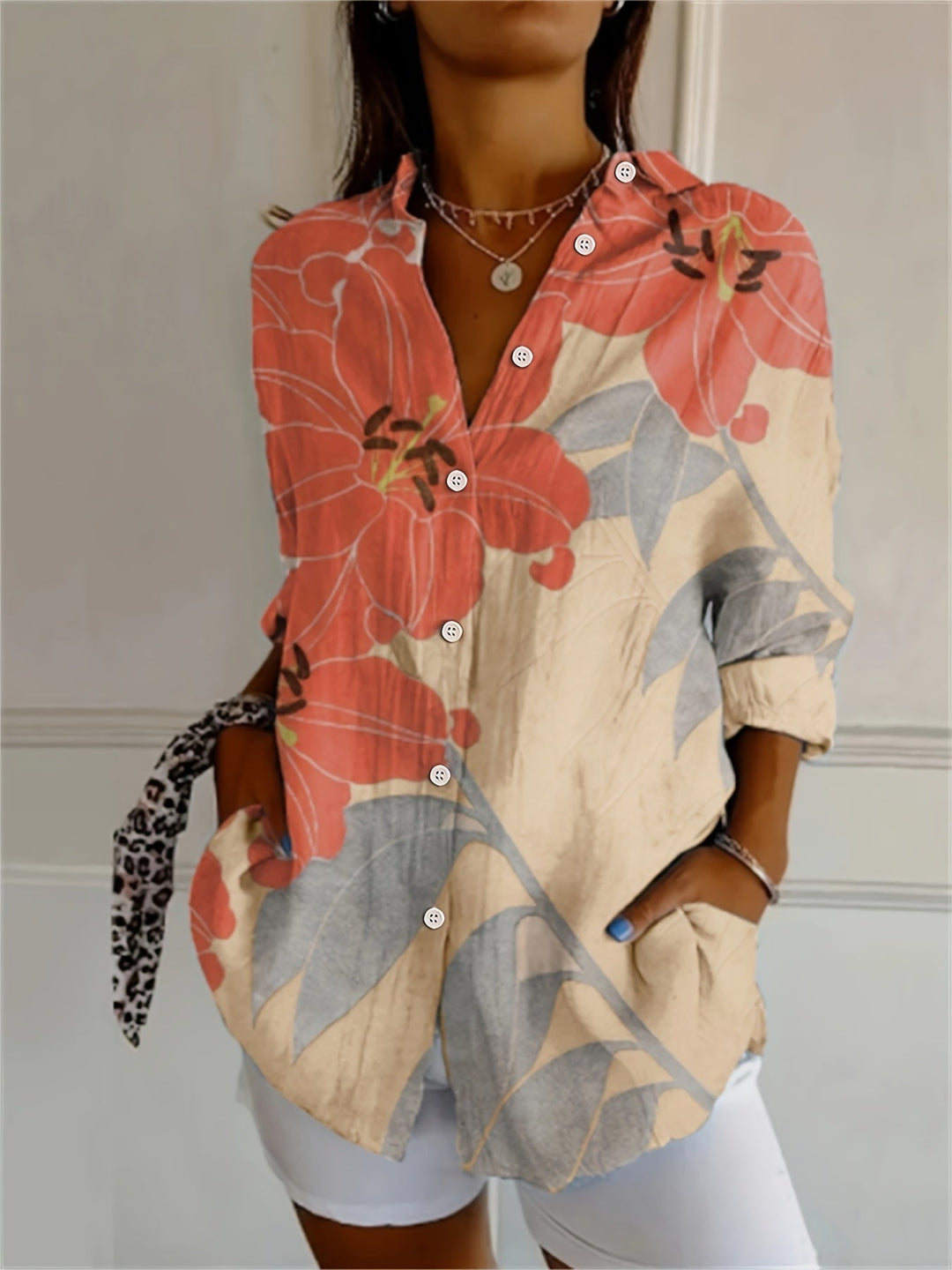 Front view of a woman wearing the retro floral V-neck blouse in apricot with long sleeves