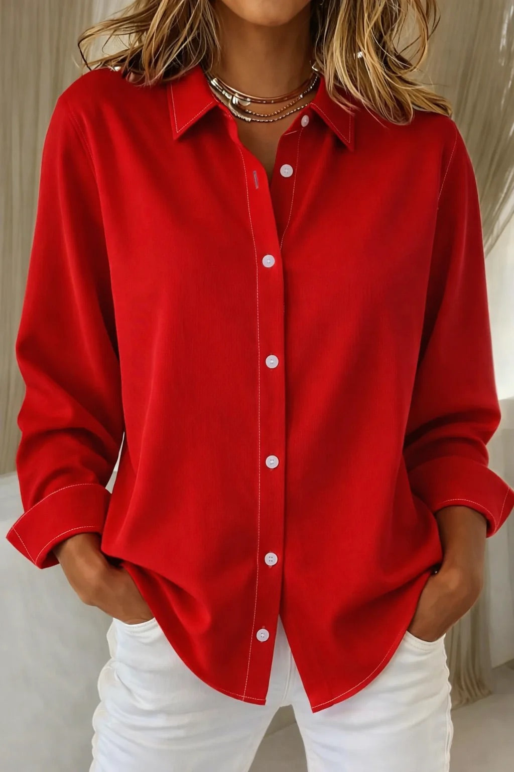 Stylish red button-down blouse paired with white trousers