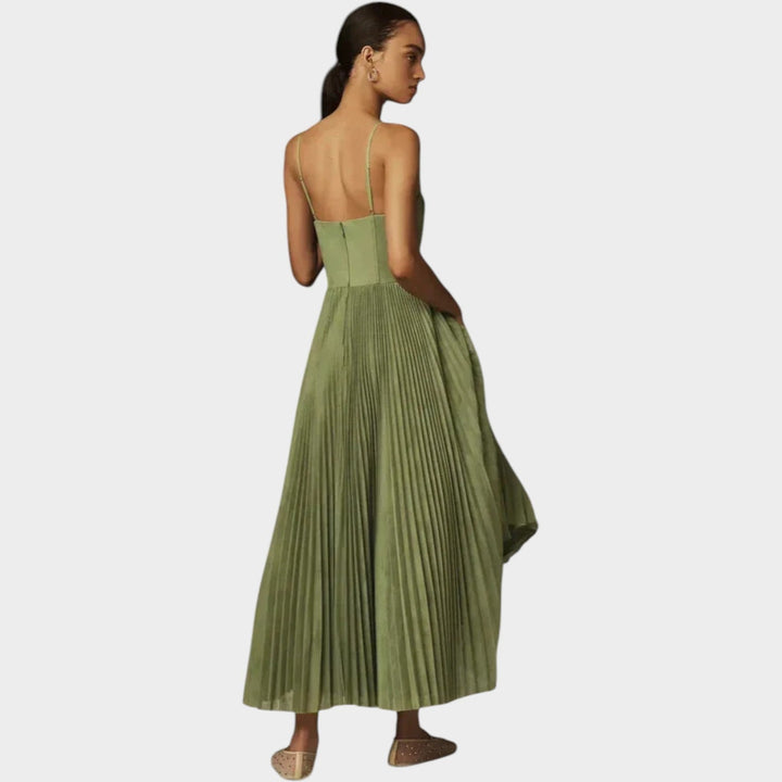 Back view of the green pleated maxi dress demonstrating the flowing skirt