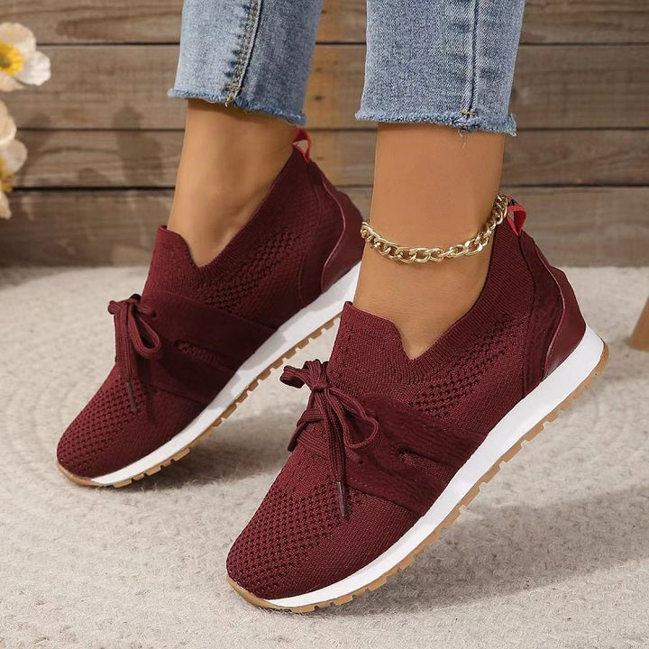 Red women's orthopedic comfort heeled shoes styled with denim