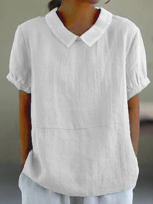 Woman wearing a white short sleeve shirt with a classic collar