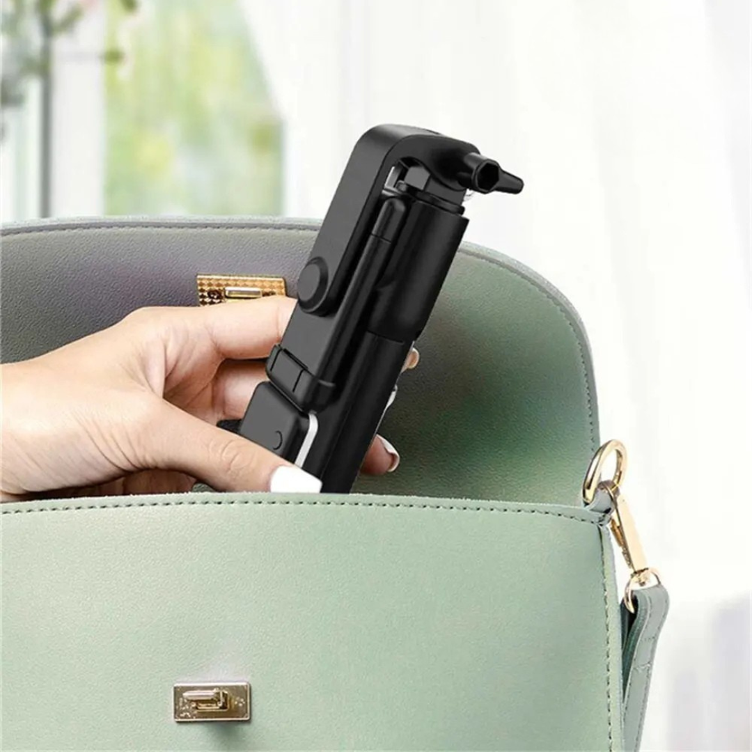 Black VeloGrip selfie stick tripod being removed from a handbag