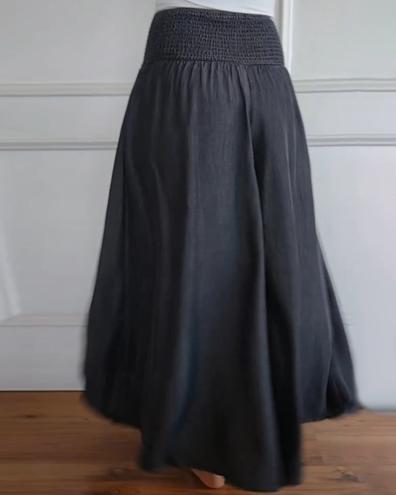 Back view of a woman wearing a dark gray long flowy skirt